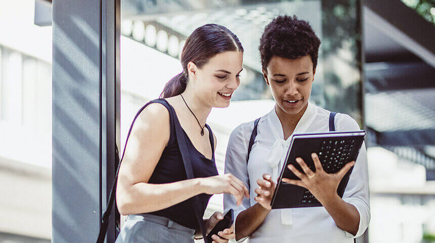 Young businesswomen at a bus station